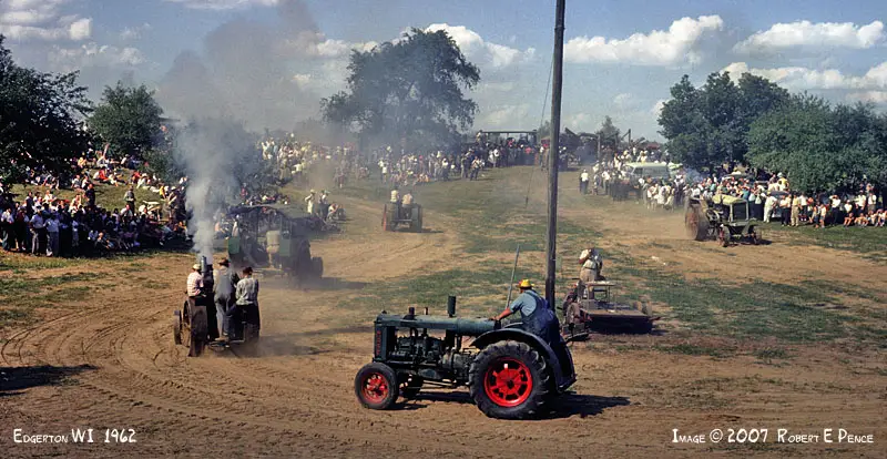 Rock River Thresheree Vintage Tractors on path with smoke Rock River Thresheree Vintage Tractors on path with smoke